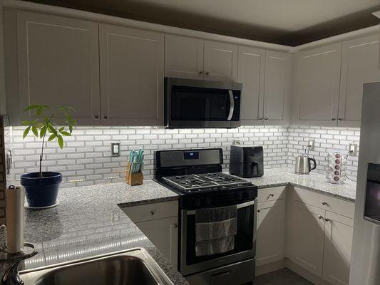 Glass tile backsplash and under cabinet lighting