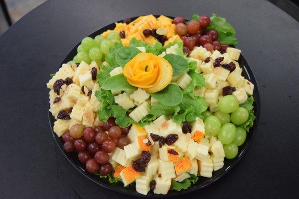 Cheese and Cracker Platter A Variety Of cheeses garnished with Grapes and dried fruits.