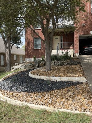 Xeriscaping under the tree where nothing will grow due to the shade and erosion.