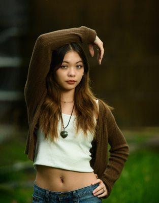 Senior girl posing at lake looking at camera