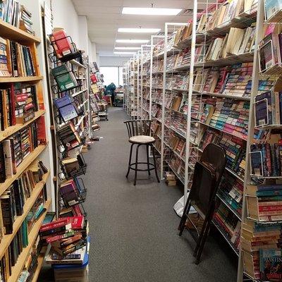 long rows of paperbacks sorted by genre