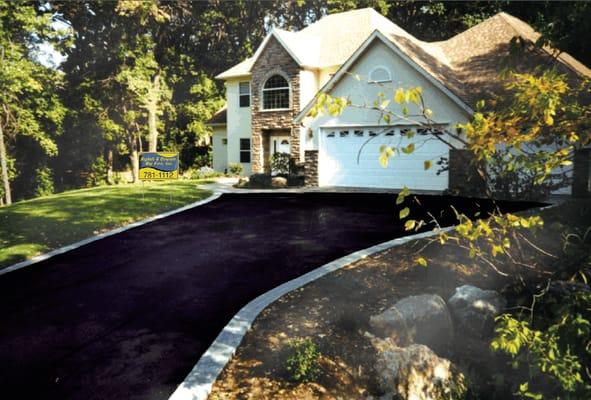 A new or refinished driveway can beautify your home!