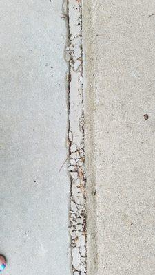 Who puts concrete in an expansion joint? This has been cracking from 3 months after the pour.