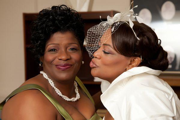 Maid of Honor receives a kiss from the bride.