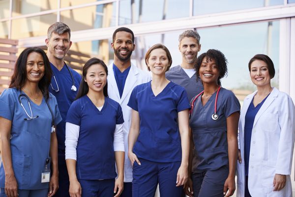 A group of doctors taking a photograph at the hospital.