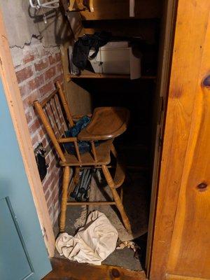 Closet with stuff thrown around inside of it.