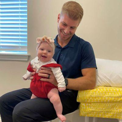 Dr. Brett adjusts baby before she meets Santa Clause! Life Family Chiropractic Nocatee