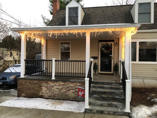 Finished front porch with new railing and flagstone steps and floor.