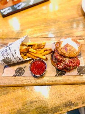 Wagyu meatball parm on a pretzel bun