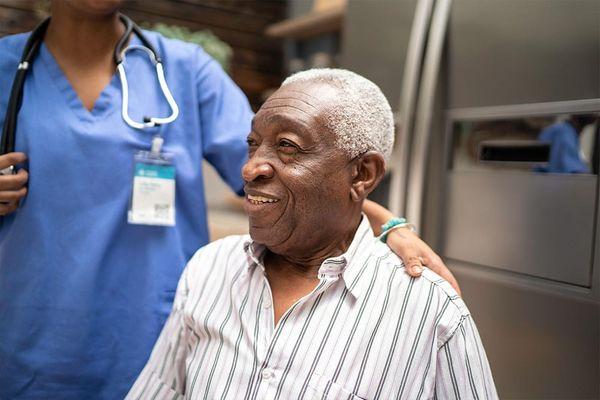 Senior resident speaking with a nurse