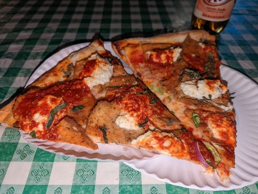 Two eggplant Parm slices with ricotta cheese.