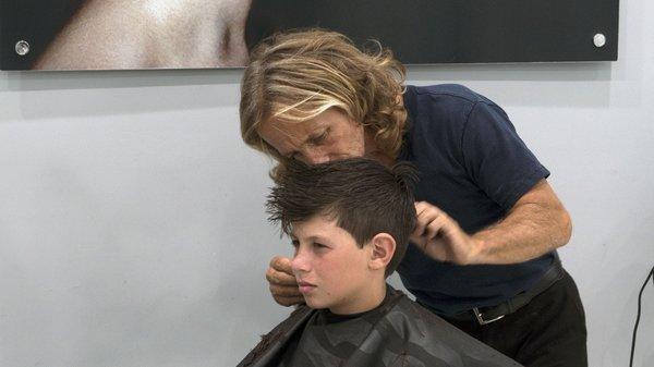 Father & Son get a haircut by Eric Ducette