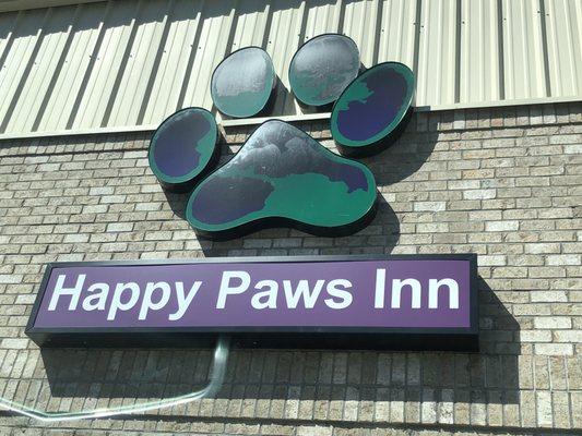 Sign above the entrance of Happy Paws Inn