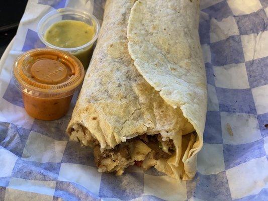 Steak burrito, beans, rice, pico de gallo, sour cream, lettuce, green hot sauce and red hot sauce on side.  The steak is very savory