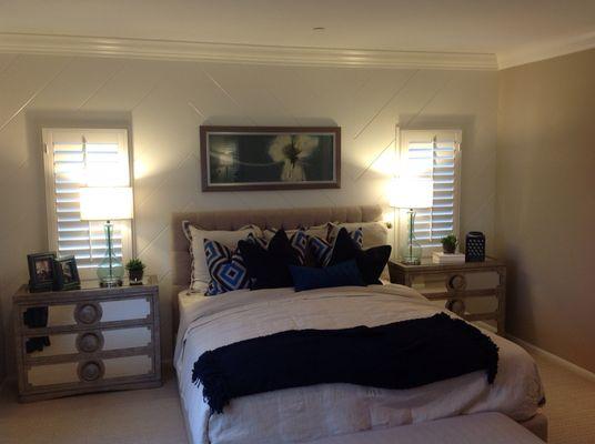 Beautiful wood shutters in bedroom.