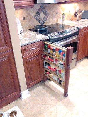 Pull out spice rack next to oven