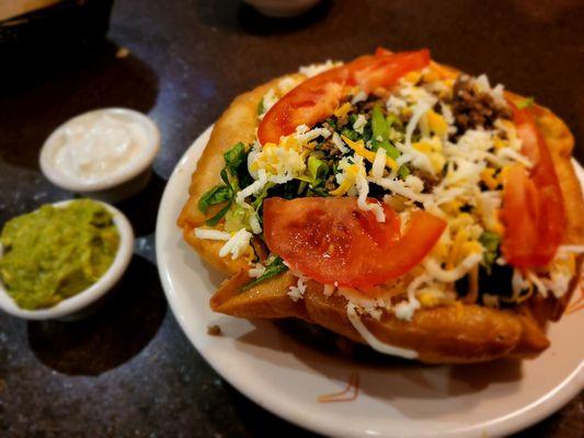 Taco Salad with side of guacamole and sour cream.