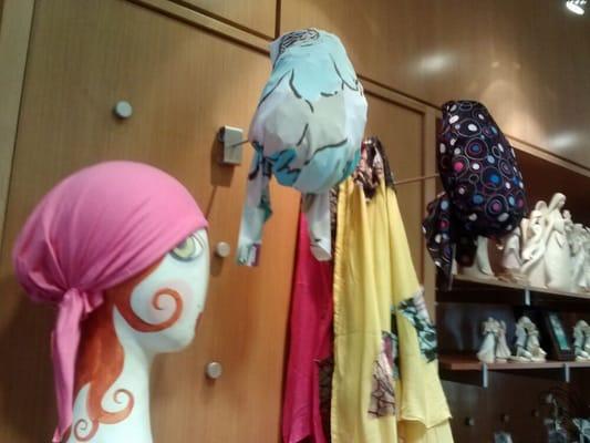 Cute hats and scarves to select from with a small area to try them on.