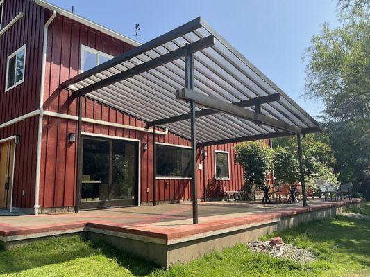 Custom clear polycarbonate panel patio cover with an all metal frame. Panels block 100% of the UV rays.