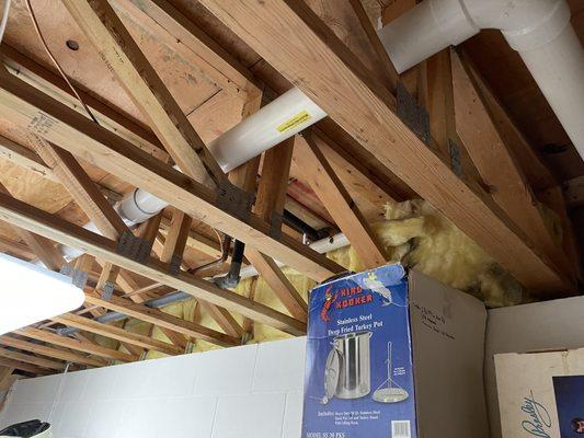 radon mitigation system piping in basement truss