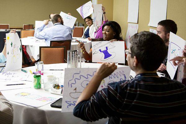 People show their work at an Ink Factory Think Like Ink workshop.