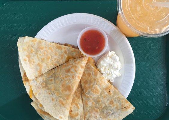 The barbacoa (spiced shredded pork) quesadilla, with sour cream, salsa, and melon agua fresca.