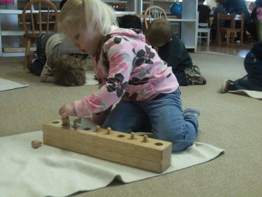 2 year old Makenzie focusing on her Knobbed/Cylinder work