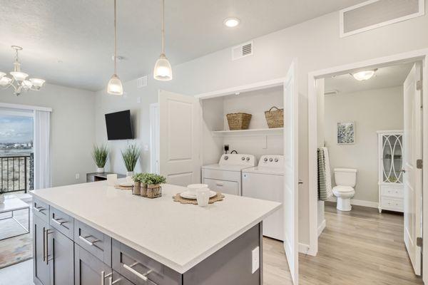 Laundry closet with a view of the living room and bathroom