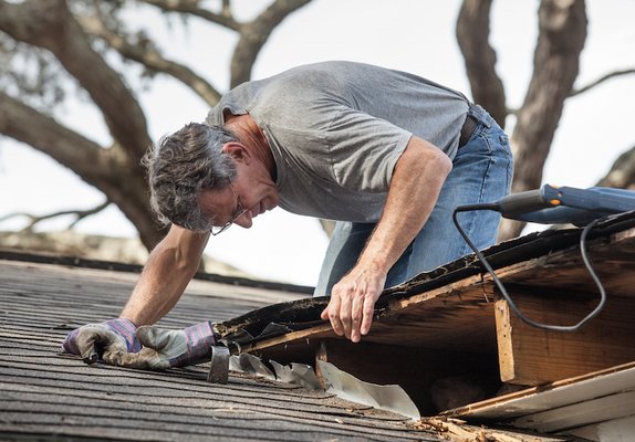 Right Roofers contractor inspecting damaged roof in Barrington, IL