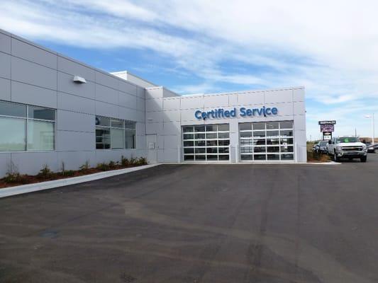 Pull up to one of these garage doors under the "Certified Service" signs on the northeast side of our building for service