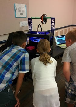 Checking out the 3D printer in action.