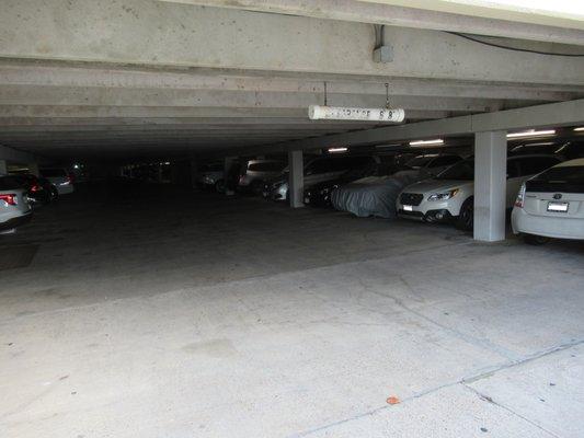 The parking garage is located underneath the swimming pool.