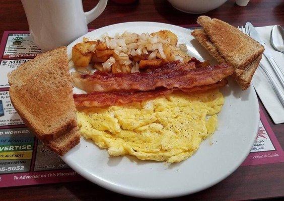 2 scrambled eggs, home fries with onions, bacon an wheat toast. Coffee.