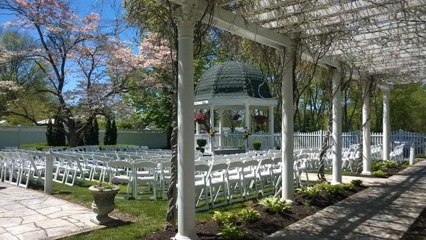 A Spring wedding ceremony around the gazebo.