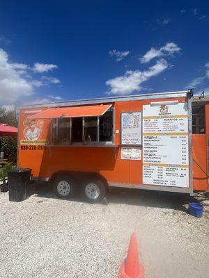 Food truck in parking lot behind church's chicken