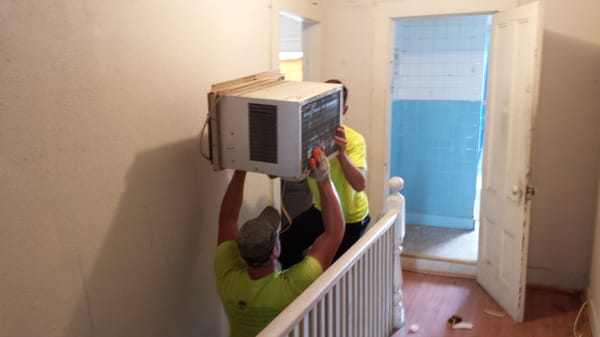 Whole House Cleanout Lowell. Working Together To Get The AC In The Truck.