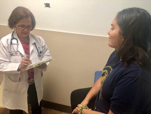 Doctor Norma B. Cornejo examining a teen patient.