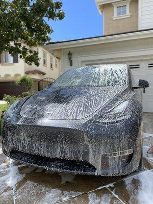 Tesla getting a spray down before it gets clay bared and waxed