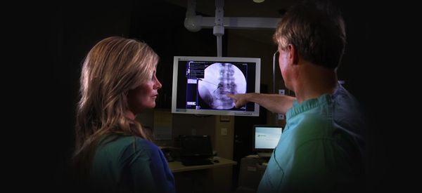 Interventional Spine Specialist, Dr. Kevin Pauza (right) and Director of Biologics, Carrie Wright (left) examining fissures i...