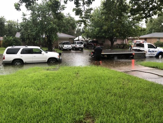 My vehicle nearly flooded and the driver out in deep water hooking my vehicle to move to dry grounds.