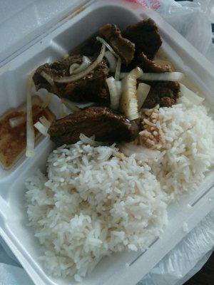 Part of a combination plate. Beef and onions with rice.