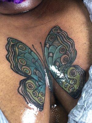 colorful butterfly in between breast by @wowinkboy on ig