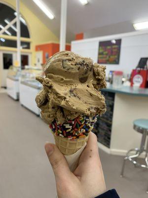 Chocolate Dipped, Sprinkle Waffle Cone with two scoops of Stellar Coffee