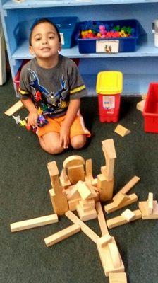 When a child builds with blocks, he uses the shaped blocks to balance and build and begins to learn math concepts.