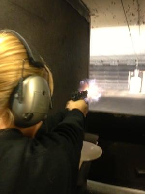 My daughter shooting her SigSauer Mosquito, and just happened to capture the muzzle flash.