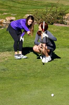 Jenn helping a client line her putt