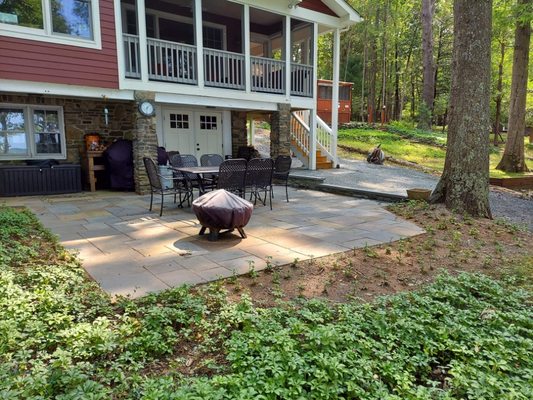 Cut flagstone patio installation, with natural stone accent wall