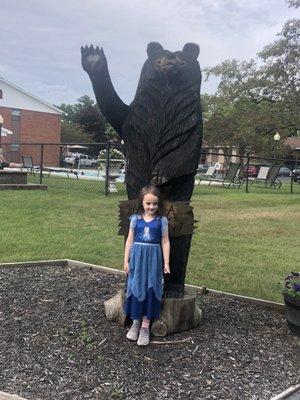 Our girl posing with the bear by the pool after we were approved.