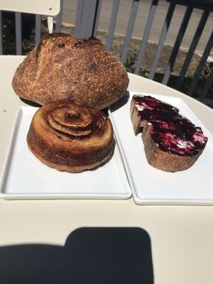 Wild loaf, cinnamon roll, toast with chèvre and raspberry jam