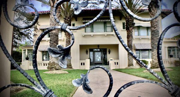 spreckles mansion as seen through the wrought iron gate